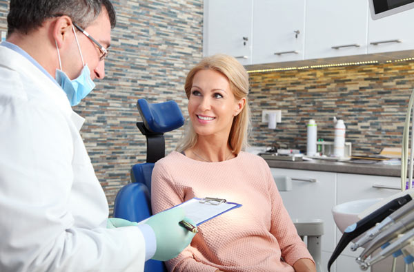 Woman talking to dentist at Lanier Valley Dentistry in Dacula, GA