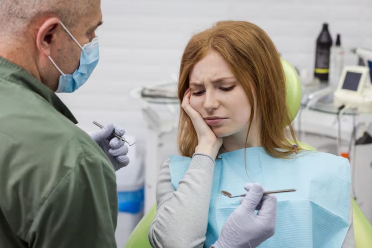 woman experiencing severe tooth pain during emergency dental consultation and treatment